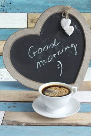  coffee served in a white cup on wooden tableの写真素材