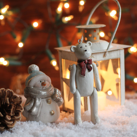 teddy bear and lantern on christmas backgroundの写真素材