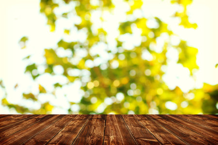 Wooden deck table with spring bokeh backgroundの写真素材