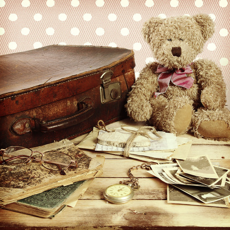 old suitcase, books, photos in retro style