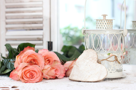 Beautiful bouquet of peach roses in shabby style on a mirror backgroundの写真素材
