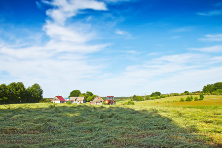 Tractor with rotary rakes in summer timeの写真素材