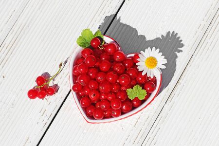 currant in a heart box on  wooden tableの写真素材
