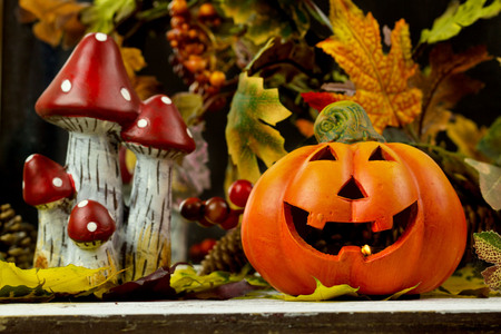 pumpkins and autumn leaves on wooden backgroundの写真素材