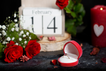 February 14 on cube calendar, red rose flower and candles, decoration for Valentines dayの写真素材
