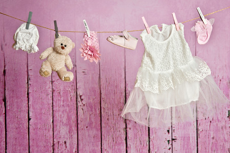 Baby clothes hanging on the clotheslineの写真素材