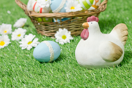 decorated easter eggs in the basket with daisies