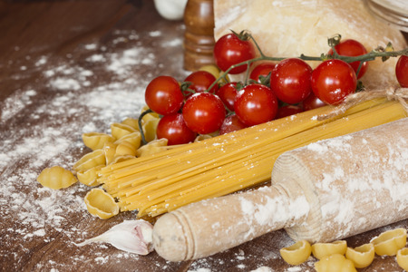 Vegetables, oil, spices and pasta on the tableの写真素材