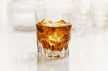 Glass of whiskey on white backgroundの写真素材