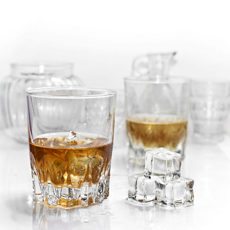 Glass of whiskey on white backgroundの写真素材