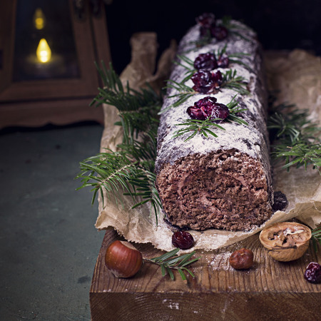 Chocolate swiss roll cake roulade with nutsの写真素材