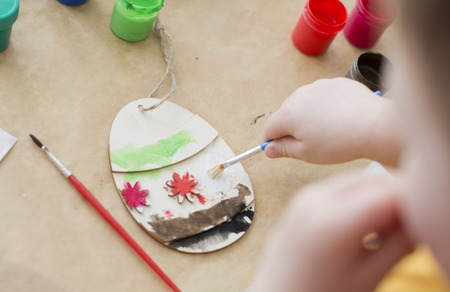 Little child  painting Easter eggsの写真素材