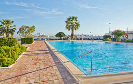 Empty sunbeds near the pool in the European hotelのeditorial素材
