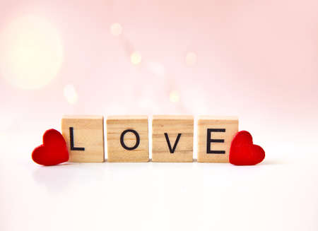 Red hearts and "Love" text on white background.の写真素材