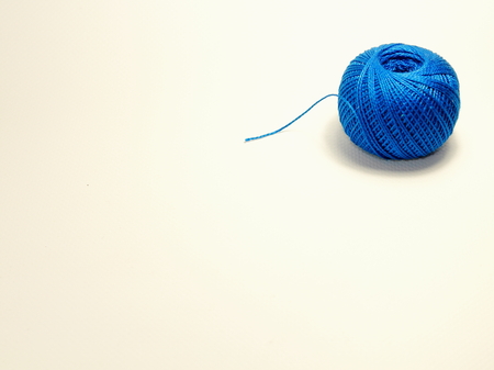 Blue ball of cotton yarn for knitting isolated on white backgroundの写真素材