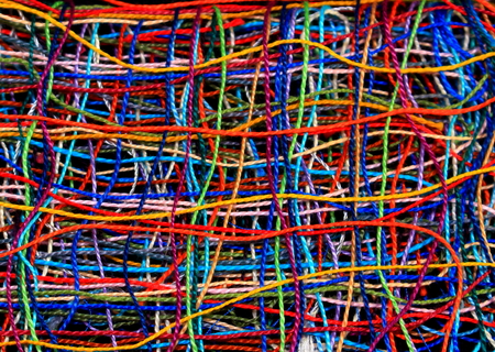 Unusual abstract background of chaotically interwoven bright cotton threads