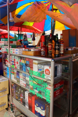 Poipet, Cambodia - Mart 27, 2018: Street sale of cigarettes and strong alcohol counter on the border of Cambodia and Thailandのeditorial素材