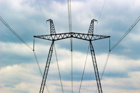 High voltage power line tower on dramatic sky