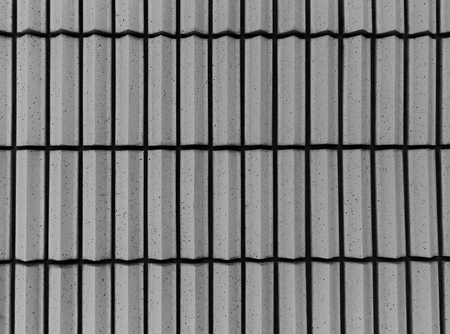 Striped ribbed wall building in grey tones for abstract background or textureの写真素材