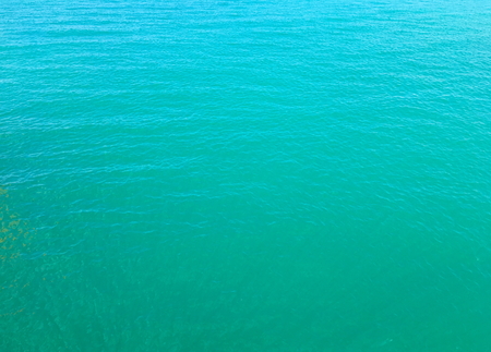 Sea water surface background. Top view on rippled azure sea wavesの写真素材