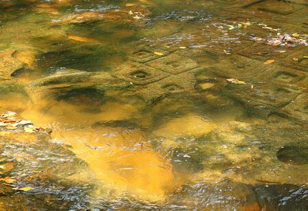 Kbal Spean (Valley of a 1000 Lingas or The River of a Thousand Lingas). The ancient motifs for stone carvings are mainly myriads of lingams (phallic symbol of Hindu god Shiva). Selective focusの写真素材