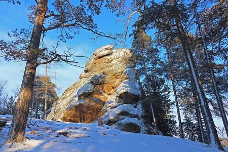 Winter view on rock pillar or Stolb a Lion Gate in Russian strict ecological reserve Stolby Nature Sanctuary near city of Krasnoyarsk. The site is known for its dramatic complexes of rocksの写真素材