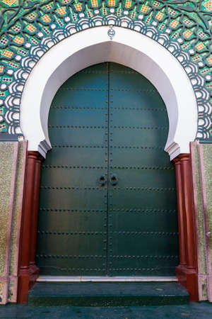 Green gateway to the mosque, Morocco. Traditional Moroccan style design of an entry doorの写真素材
