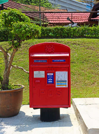 Kuala Lumpur, Malaysia - Mart 14, 2019: Red postbox or mailbox at urban street in Kuala Lumpur