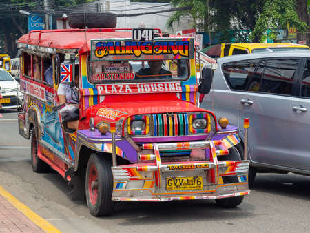 Cebu, Philippines - October 3, 2018: colorful passenger jeepney with bright designs on city street. Popular public transport at Philippinesのeditorial素材