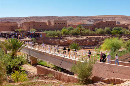 Ouarzazate, Morocco - 15 October, 2019: pedestrian tourist bridge across the Ounila River connecting village and ancient Ait Benhaddou Kasbah near Ouarzazate city Morocco, North Africaのeditorial素材