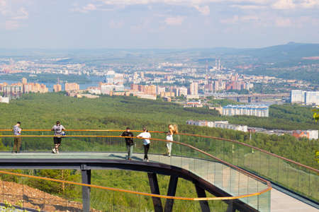 Krasnoyarsk, Russia - June 17, 2021: People sightseeing and are photographed on the observation deck on Nikolaevskaya Sopka. Cityscape view of Krasnoyarskのeditorial素材