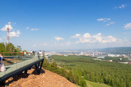 Krasnoyarsk, Russia - June 17, 2021: Observation platform on Nikolaevskaya Sopka with people who look at landscape of Krasnoyarskのeditorial素材
