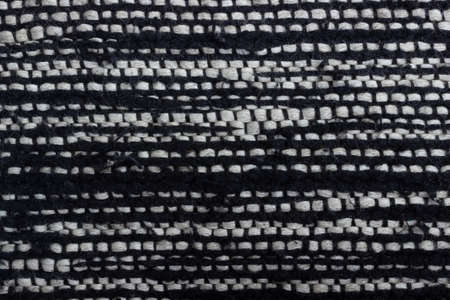 Fabric texture weave a large wool thread. Black and white material. Woven textured background with...