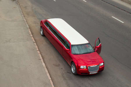 Krasnoyarsk, Russia - June 28, 2021: Red Chrysler 300c limousine with open doorのeditorial素材