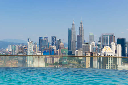 Kuala Lumpur, Malaysia - March 16, 2019: infinity swimming pool with panoramic view on the roof of a skyscraper in Kuala Lumpur city, Malaysia.のeditorial素材
