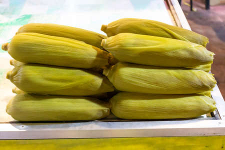 Fresh sweetcorn on the cob on the counter of a street vendorの写真素材
