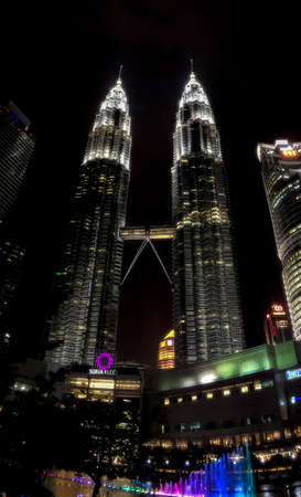 Kuala Lumpur, Malaysia - March 11, 2019: night view on glowing skyscrapers of the Petronas Twin Towers with colorful fountain in Kuala Lumpur, Malaysia.のeditorial素材
