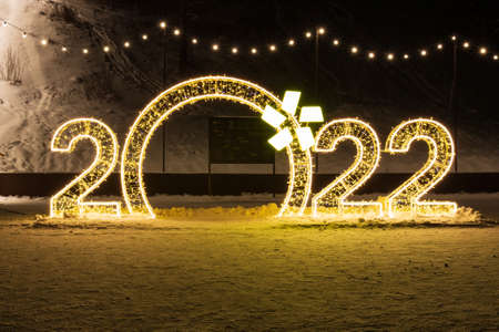 Krasnoyarsk, Russia - 30 December, 2021: Sparkling golden numbers 2022 year at night. Christmas and...