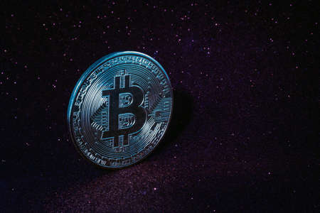 Silver Bitcoin on sparkling purple sky background with copy space. A symbol of wealth and success. Exchange trading, Business and Banking concept.の写真素材