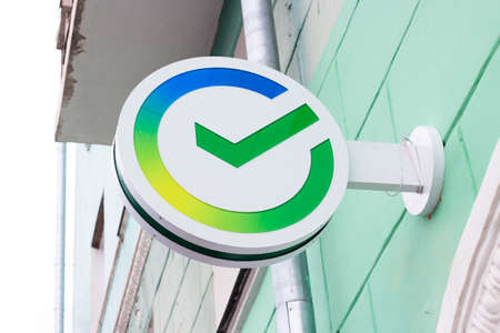 Krasnoyarsk, Russia - February 25, 2022: The logo of the Russian Sberbank bank above the entrance of one of its branch officesのeditorial素材