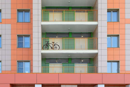 Bicycle on the balcony of a multi-storey residential buildingの写真素材