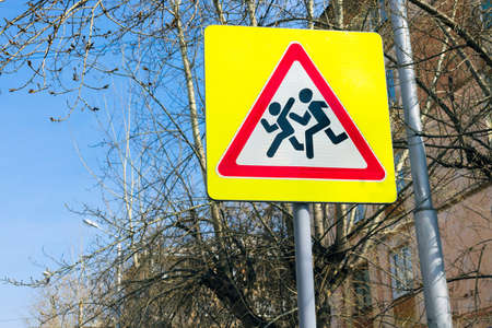 Road warning sign Caution children in city street