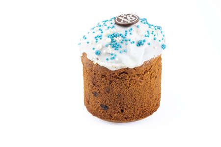 Russian Kulich with white top and blue sprinkles. Chocolate egg with Paschal greeting or Easter...
