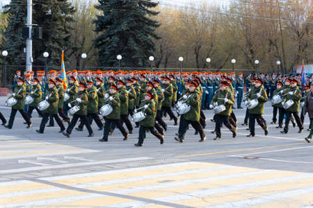 Krasnoyarsk, Russia - May 5, 2022: A group of military musicians-drummers in full dress march during...