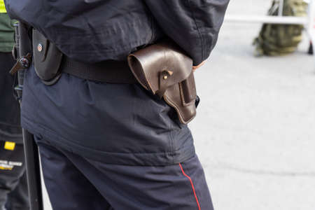 Brown leather old pistol holster on the belt of a Russian policeman