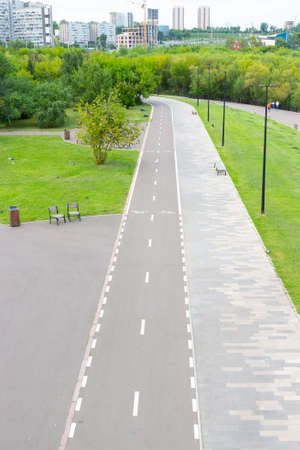 Summer landscape with empty pedestrian and bicycle paths in the city park. top viewの写真素材