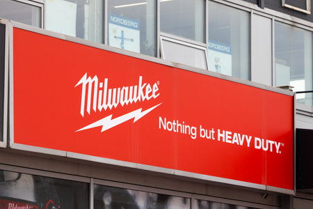 Krasnoyarsk, Russia - July 01, 2022: Milwaukee brand logo on a wall of a dealer. 'Milwaukee' is a brand of power tools manufactured by the American company Milwaukee Electric Tool Corporationのeditorial素材