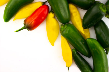 Red and green jalapeno peppers with yellow lemon drops pepper isolated on white background. top view and copy spaceの写真素材