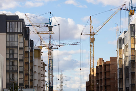 Cranes on construction site are working for the construction of a new residential city block....