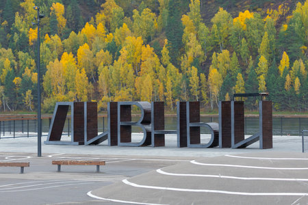Divnogorsk, Russia - September 20, 2022: Giant wooden letters DIVNY on the colorful autumn embankment of the Yenisei river in Divnogorsk town, Krasnoyarsk krai, Russiaのeditorial素材
